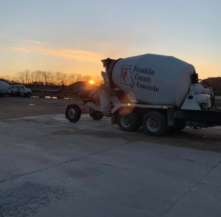 Franklin County Concrete mixing truck on worksite with sunrise in background